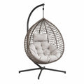 Sedia a dondolo sospesa in rattan e acciaio con cuscino beige